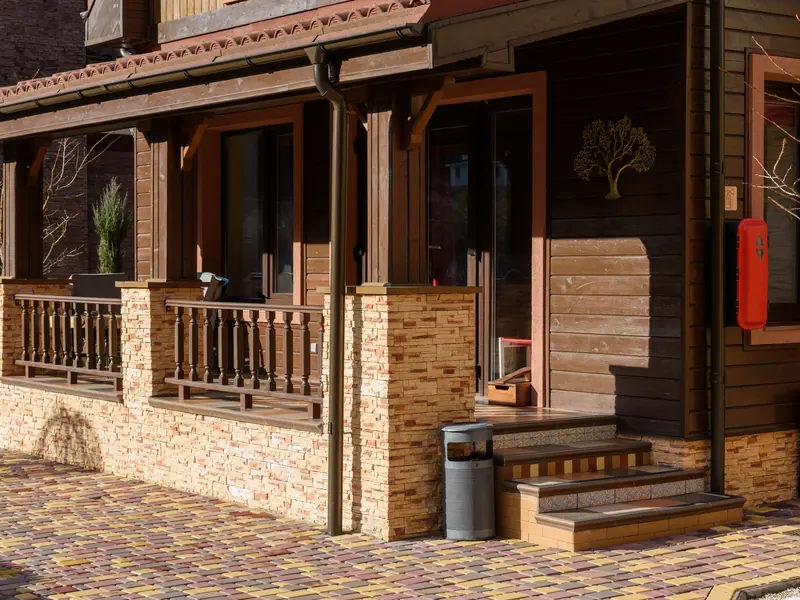 Wood-sided home with a covered porch and stone accents