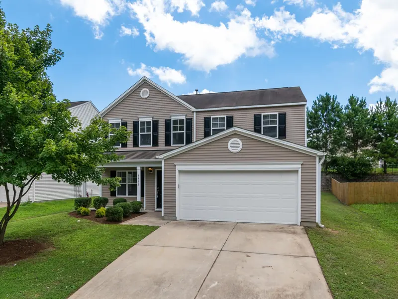 Two-story home with light siding and a two-car garage